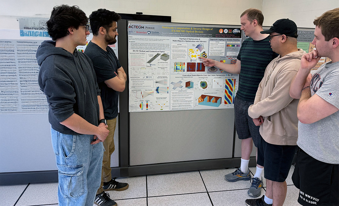 students viewing a poster presentation