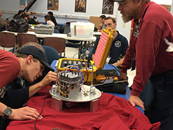 A student works on the equipment in a lab