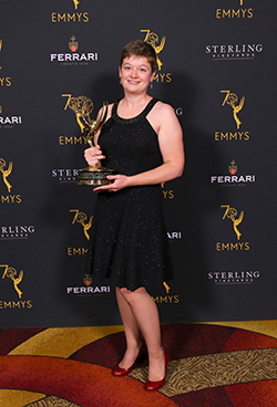 Woman holds Emmy trophy