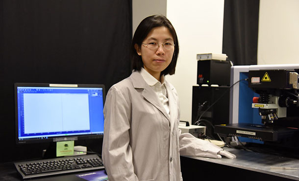 Shengxi Huang stands in her lab