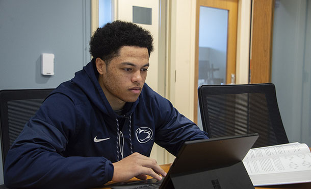 A student works on his laptop